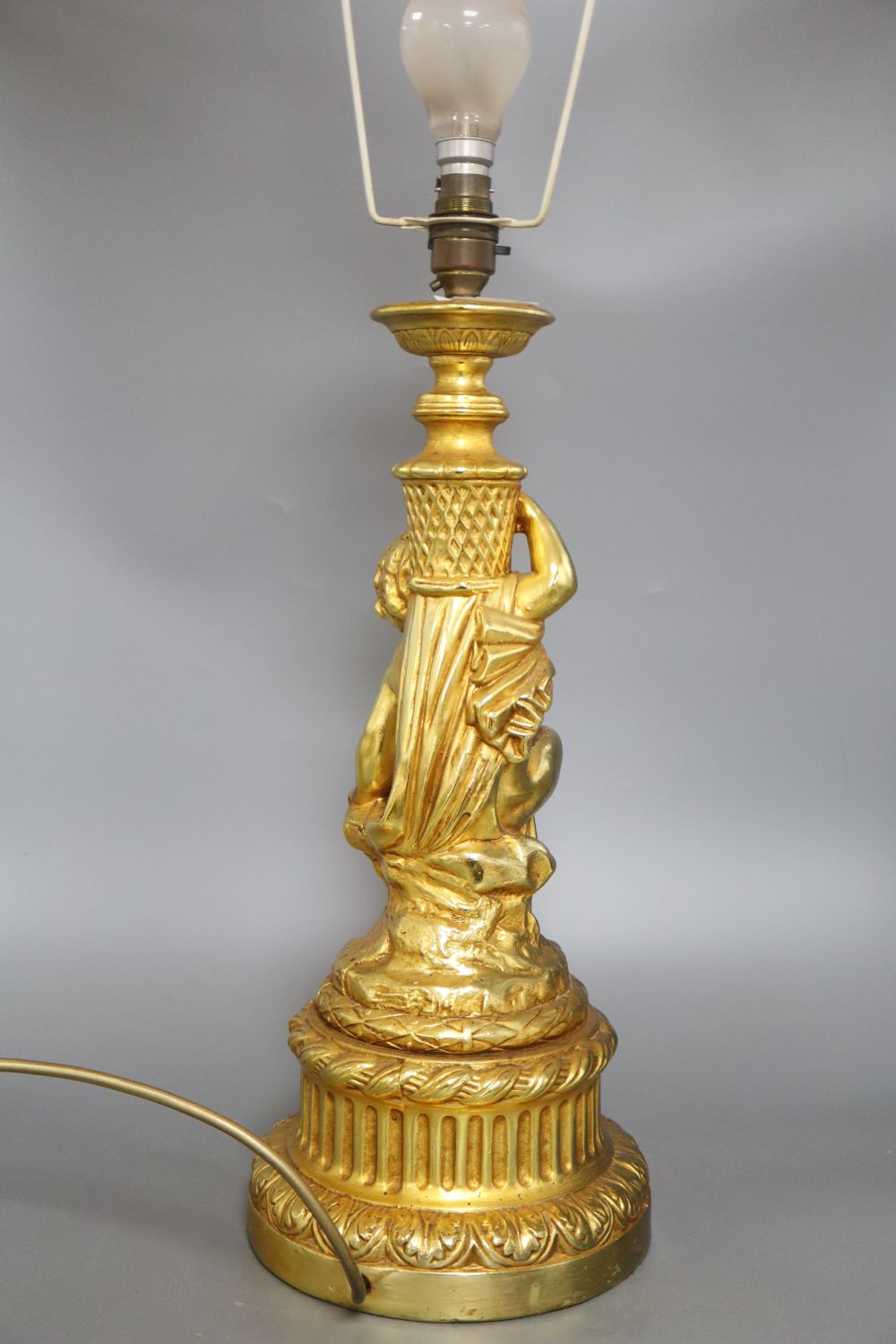 A gilt plaster cherub table lamp